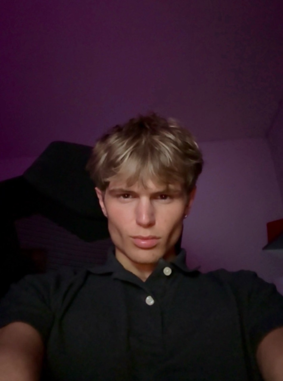 Front-facing portrait wearing a black polo
